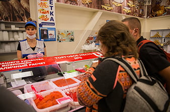 tourists choose fish at the counter