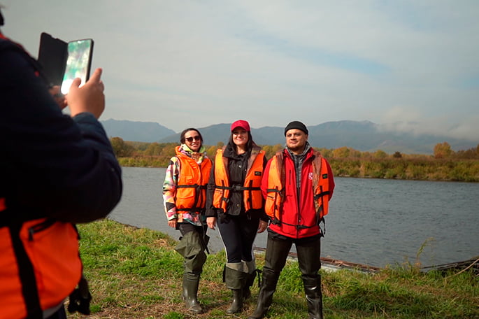 tourists take photos before the start of the rafting trip
