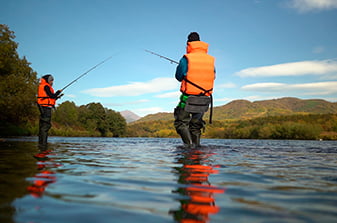 tourists fish during the salmon spawning season